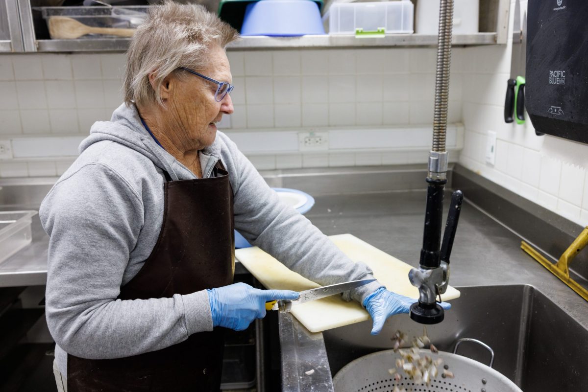 A volunteer chops seafood