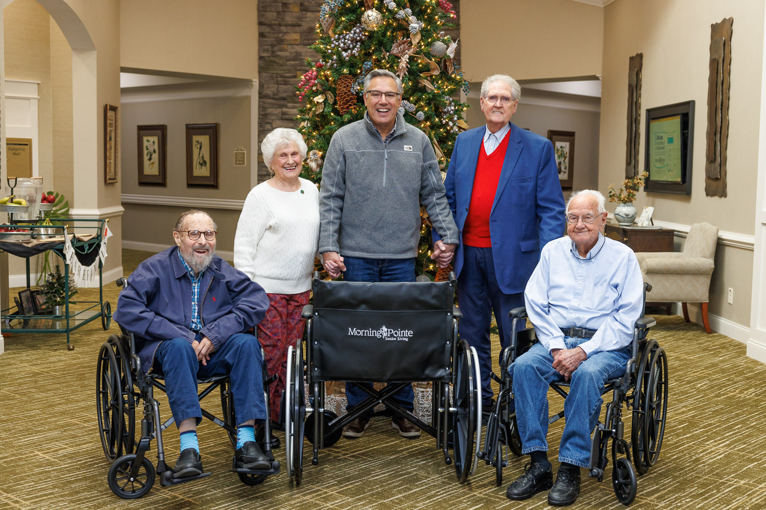 People posing with wheelchairs