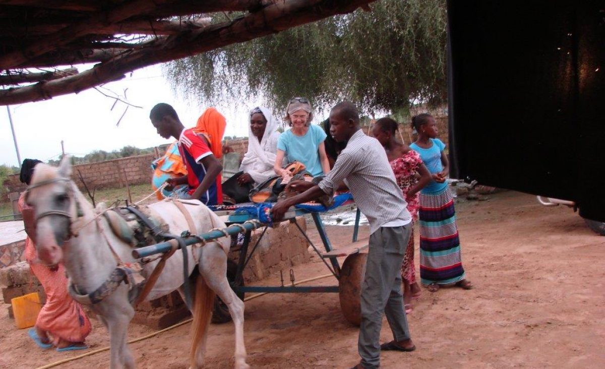 Archival photograph of Tennessee Aquarium Senior Horticulturist Charlene Nash with family farmers in Mozambique.