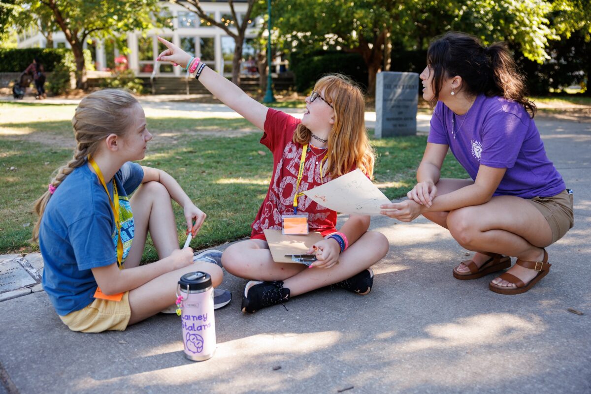 Jim Hill Education Fellow Trenity Newell helps campers with a bird-search activity during Tennessee Aquarium summer camp.